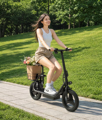 Donna alla guida del monopattino elettrico APEFOX C14 su un vialetto