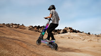 Pilota con il monopattino elettrico APEFOX T90 ULTRA in fuoristrada nel deserto