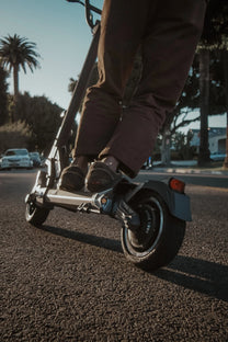 Persona alla guida del monopattino elettrico DUALTRON TOGO in una strada