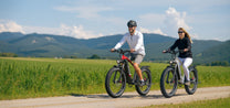 Due persone con la fat bike elettrica Duotts F26 Lite su un vialetto