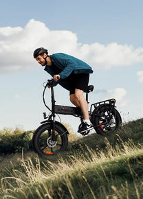Uomo alla guida della fat bike elettrica pieghevole ENGWE ENGINE X su un prato