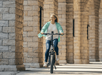 Donna alla guida della bici elettrica pieghevole ENGWE L20 3.0 Boost in città