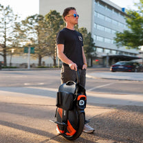 Uomo in piedi con il monociclo elettrico InMotion V11Y in città