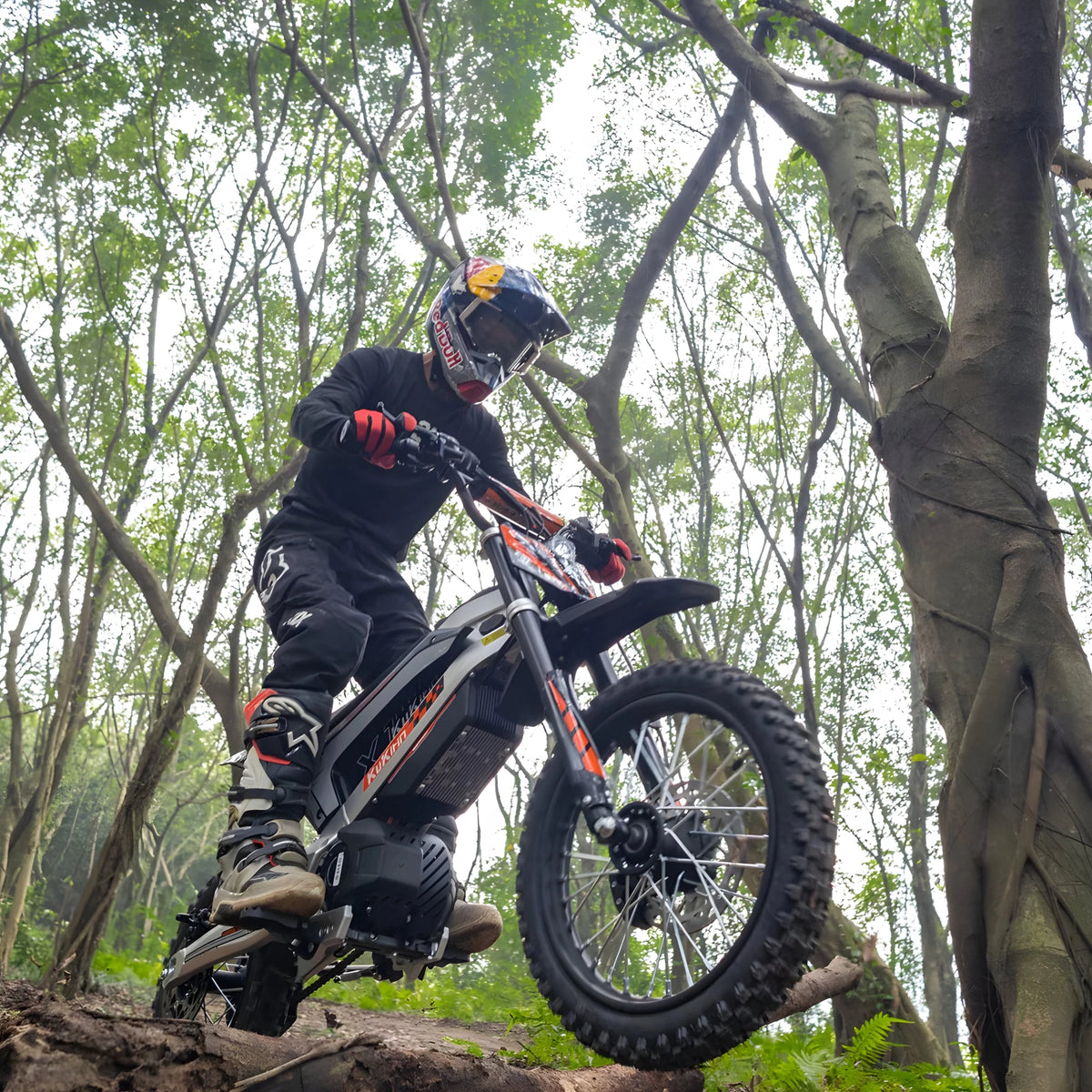Pilota con la moto da cross elettrica KuKirin X1 in fuoristrada nel bosco
