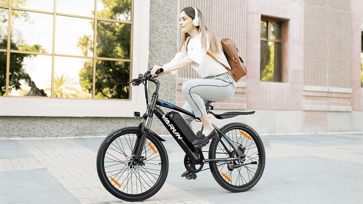 Donna alla guida della mountain bike elettrica VARUN M24-1 in colore nero in città