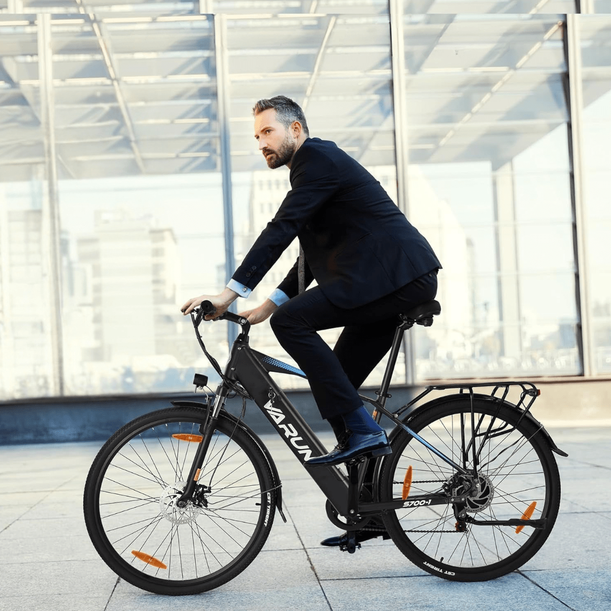 Uomo alla guida della bici elettrica VARUN S700-1 in colore nero in città